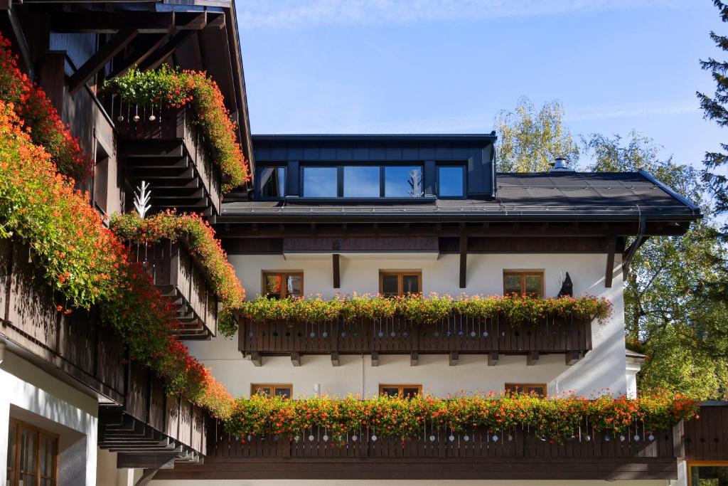 a building with flower boxes on the balconies at Valluga Hotel in Sankt Anton am Arlberg