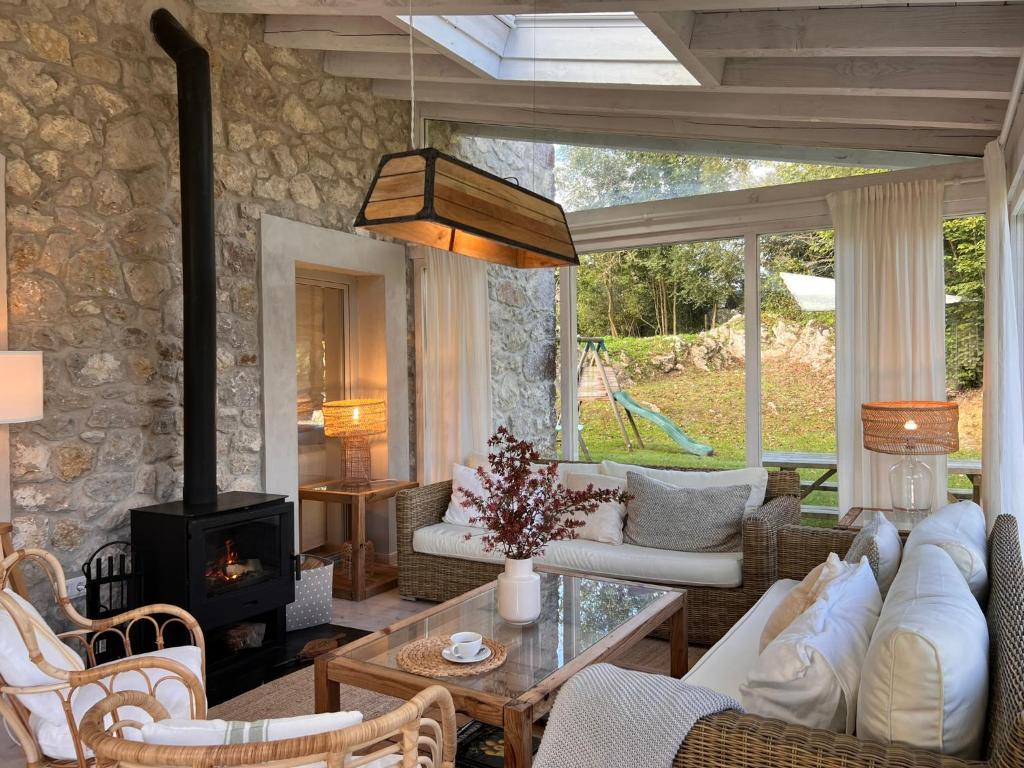 a living room with a couch and a fireplace at Wishome-Cuadra rehabilitada, piscina climatizada in Lamadrid