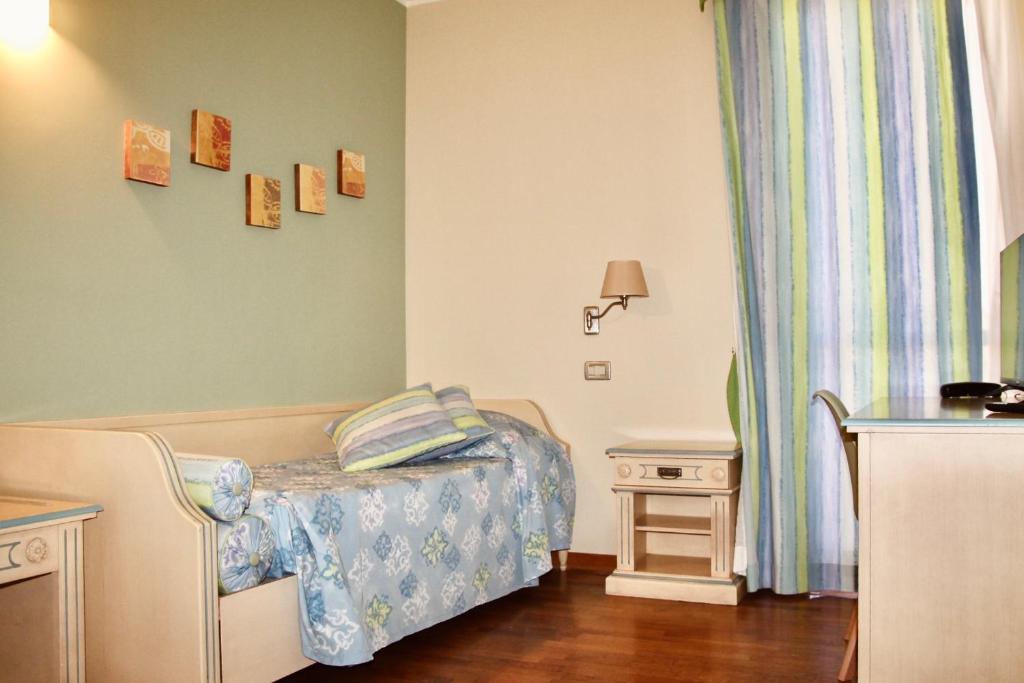 Postel nebo postele na pokoji v ubytování Hotel Matteotti
