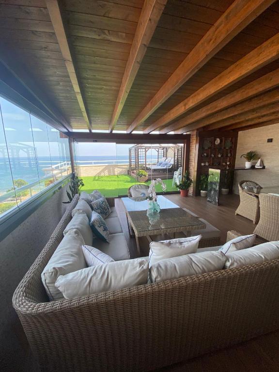 a large living room with a couch and a table at Atico LUXURY Magic World in Oropesa del Mar