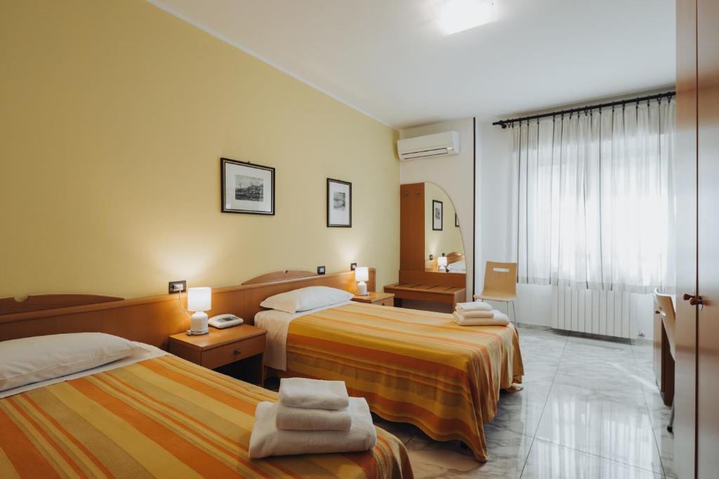 Postel nebo postele na pokoji v ubytování Hotel Passacor - Business & Bike