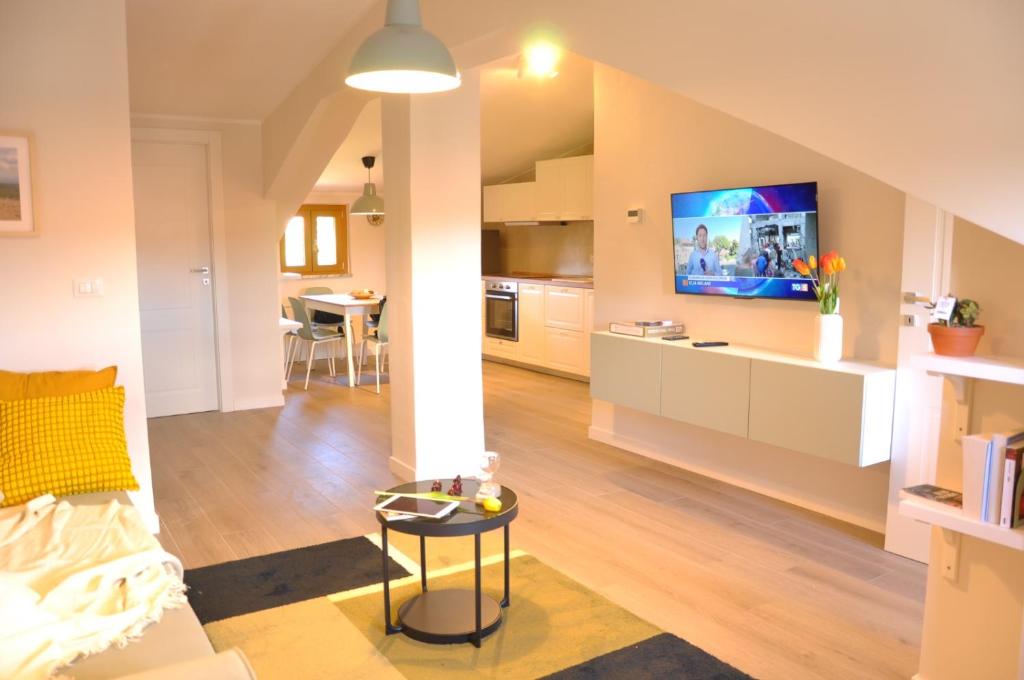 a living room with a couch and a tv on a wall at Nike Apartment in Roccamonfina