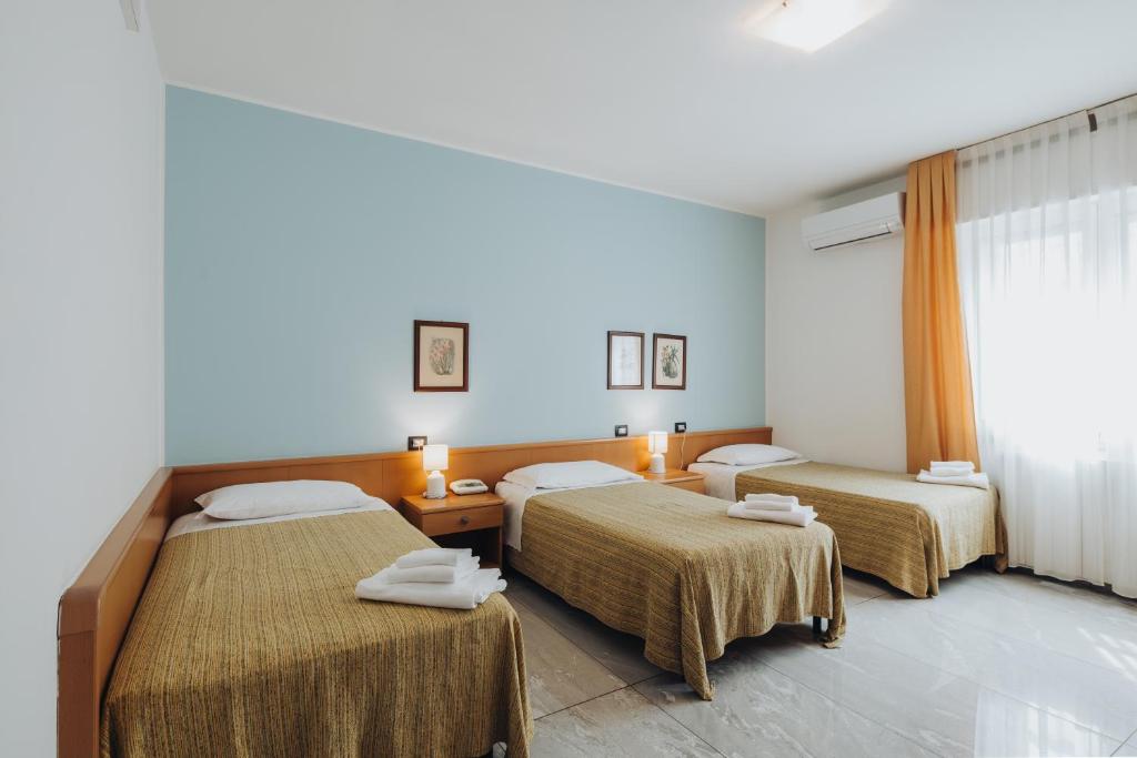 Postel nebo postele na pokoji v ubytování Hotel Passacor - Business & Bike
