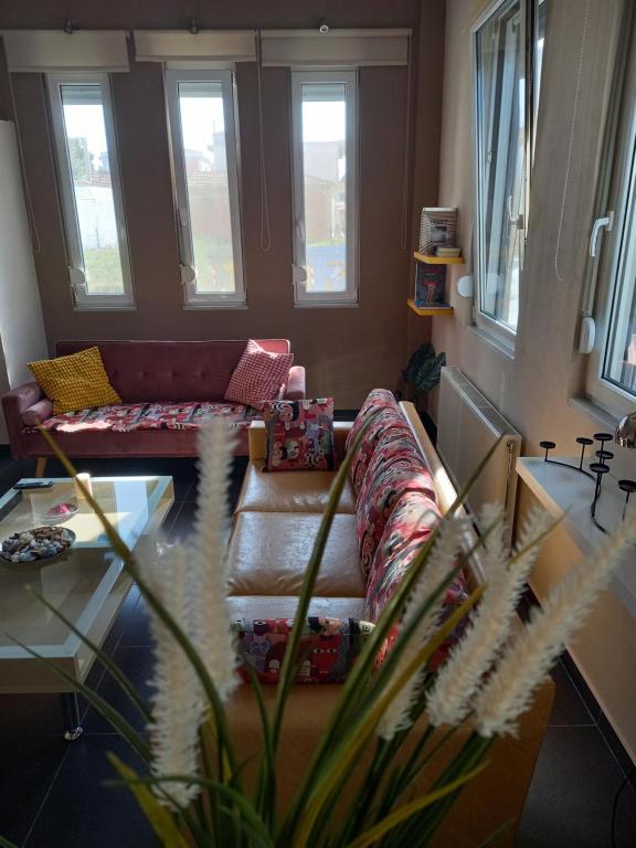 a living room with a couch and a glass table at uRban Loft Living in Karditsa