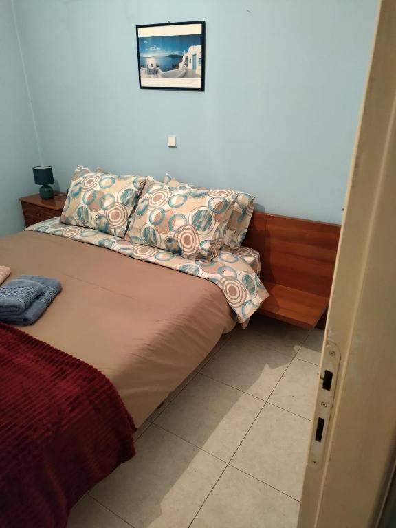 a bed with pillows on it in a bedroom at Αποστολος in Tríkala