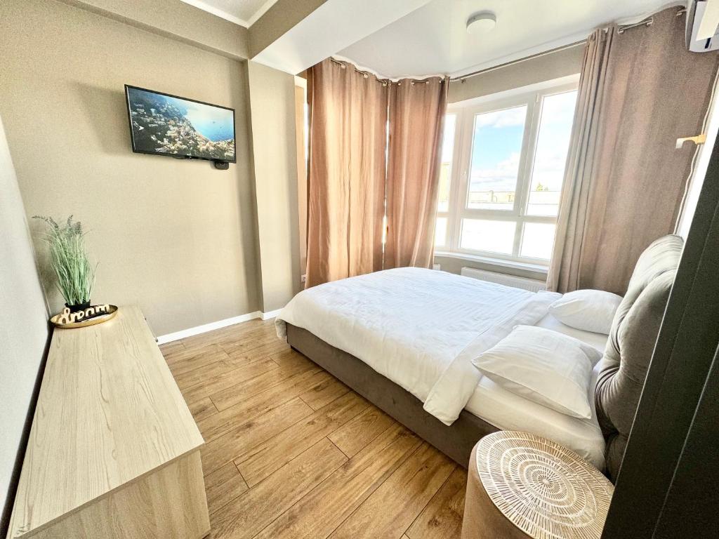 En eller flere senge i et værelse på Квартира в новострое на Ботанике