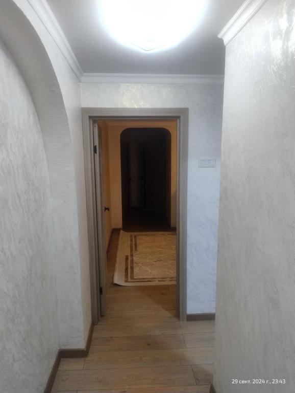 a hallway with a hallway leading into a room with a ceiling at 3-х комнатная квартира Аэропорт in Turksib