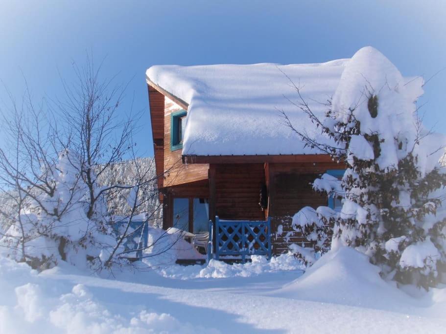 a log cabin with snow on top of it at Chalet au cœur du massif des Bauges in La Féclaz