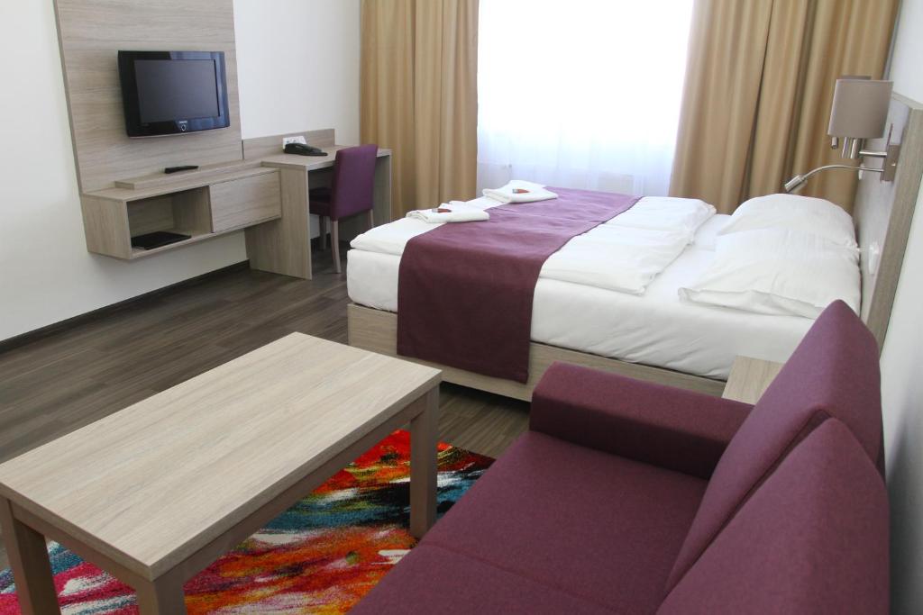 Postel nebo postele na pokoji v ubytování Hotel Palác Elektra