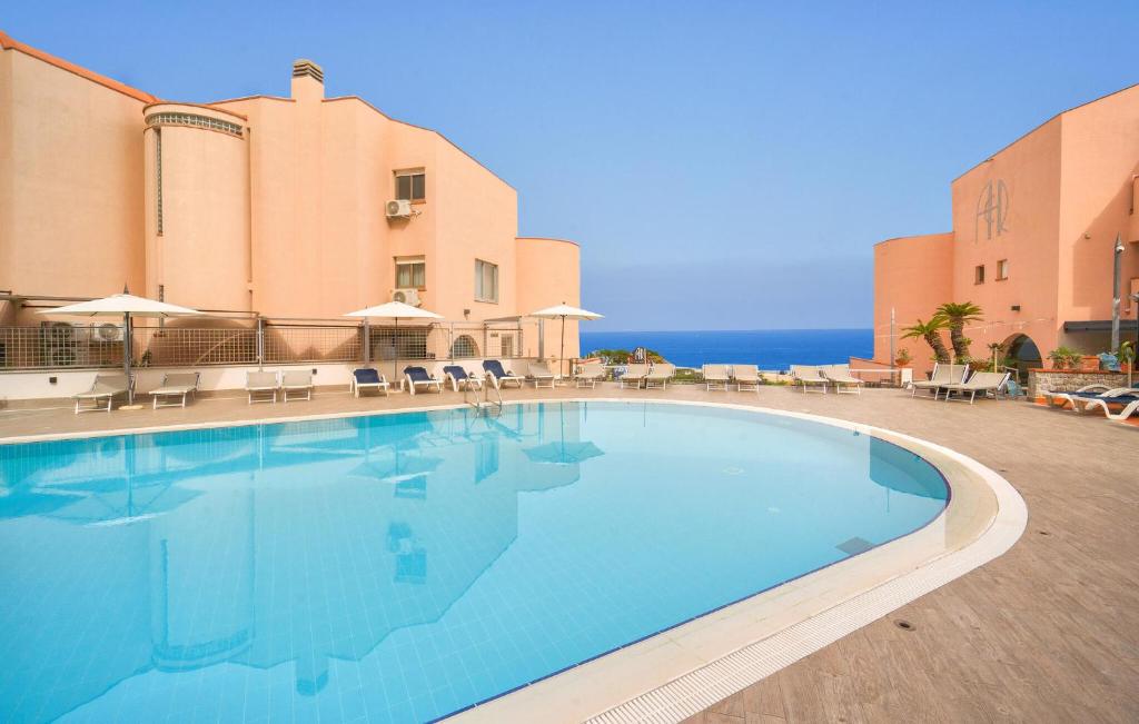 a large swimming pool in front of a building at Mono 2 in Lido di Mondello