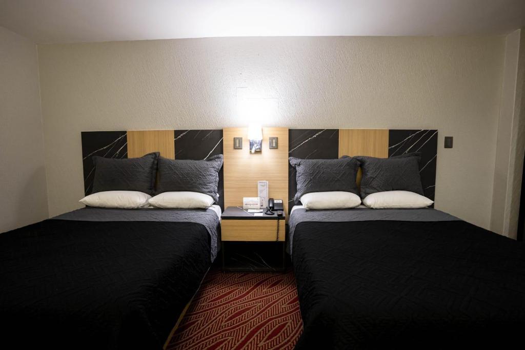 Postel nebo postele na pokoji v ubytování Hotel Real Plaza