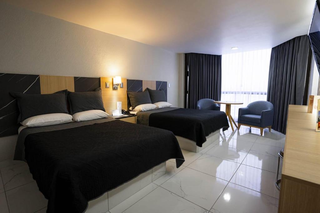 Postel nebo postele na pokoji v ubytování Hotel Real Plaza
