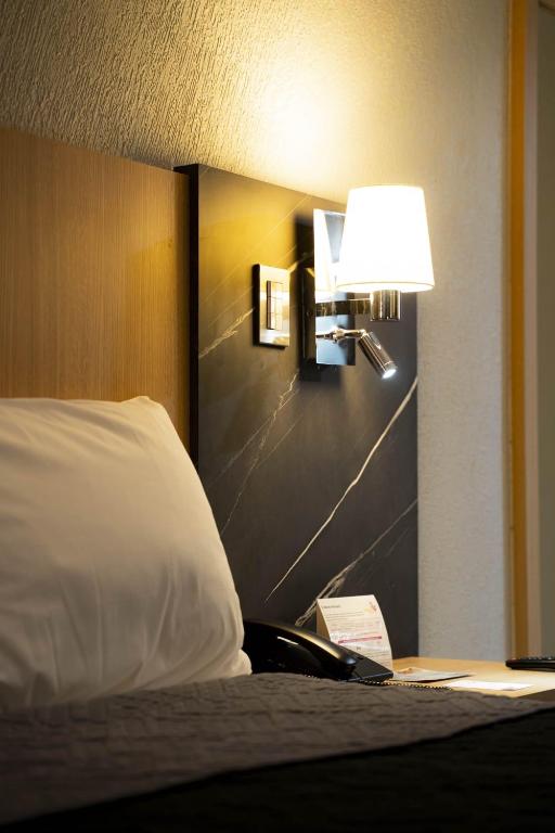 Postel nebo postele na pokoji v ubytování Hotel Real Plaza
