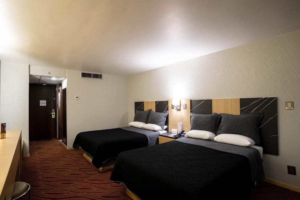 Postel nebo postele na pokoji v ubytování Hotel Real Plaza