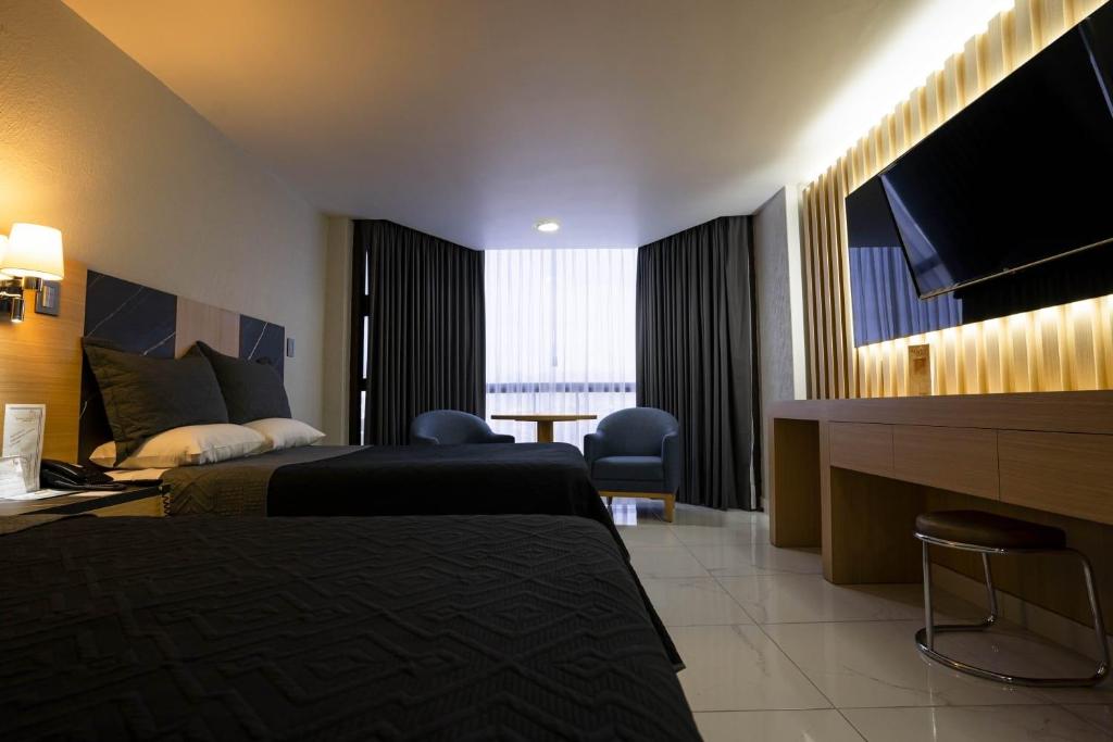 Postel nebo postele na pokoji v ubytování Hotel Real Plaza