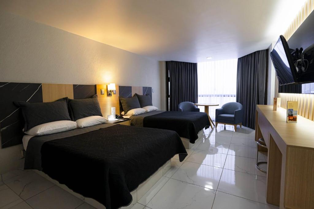 Postel nebo postele na pokoji v ubytování Hotel Real Plaza
