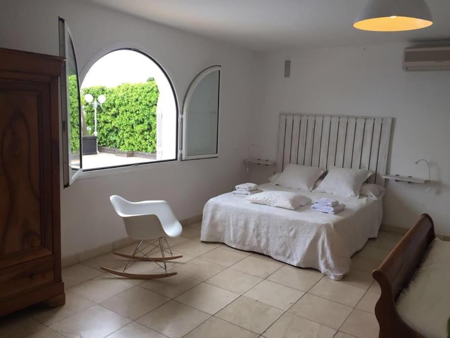 a bedroom with a bed and a chair in it at House Seaviews Barcelona 22Km in Cabrils