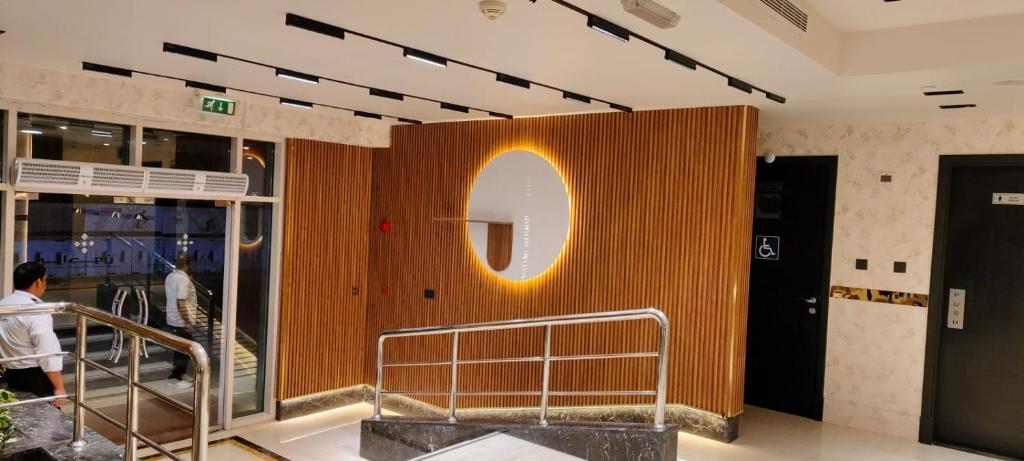 a wall with a sign on it in a building at Paragon Hotel Apartments in Abu Dhabi