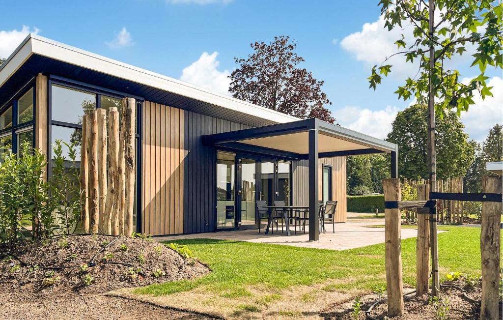 a small house with glass doors and a patio at 2 Bedroom Gorgeous Home In Voorthuizen in Voorthuizen