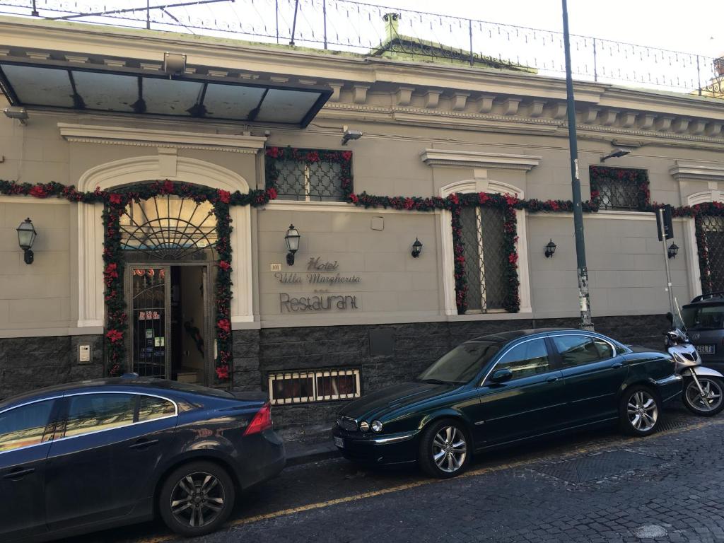 two cars parked in front of a building at Villa Margherita in Naples