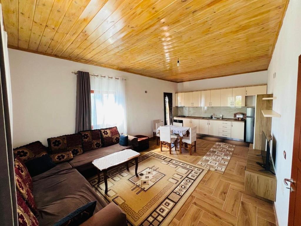 a living room with a couch and a table at Bert-House close to the sea in Lezhë