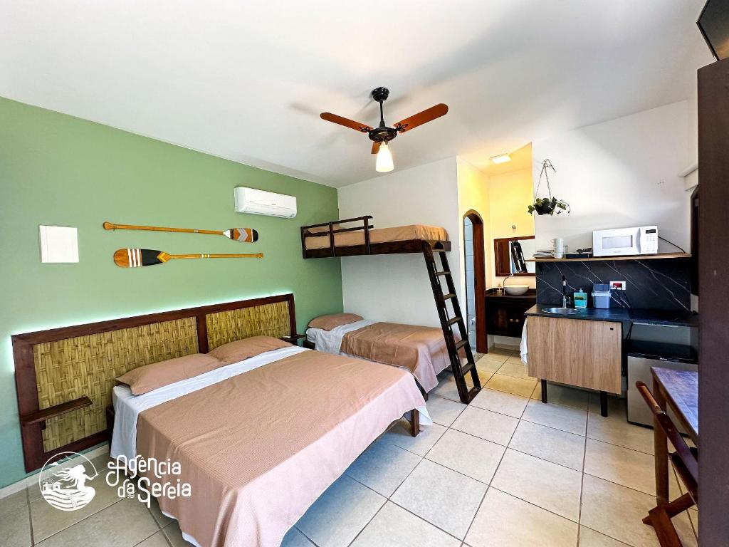 a bedroom with two beds and a bunk bed at Casa Naturaleza in Ilhabela