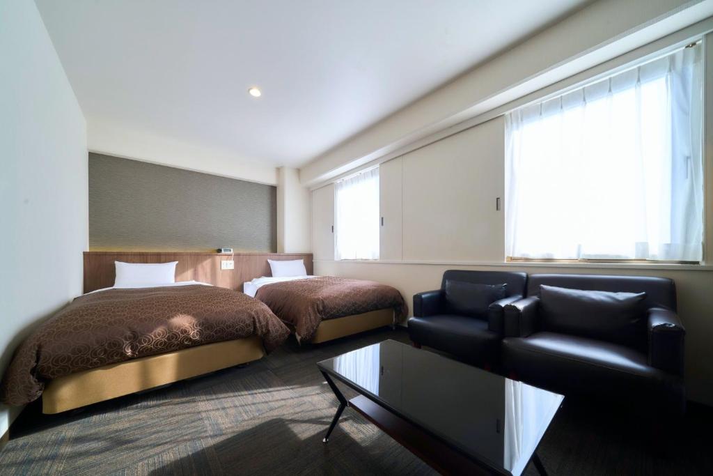a hotel room with two beds and a couch at Minakuchi Century Hotel - Vacation STAY 35331v in Koka