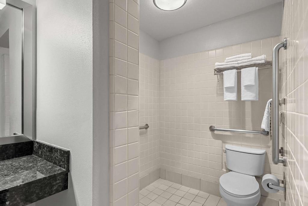 a white bathroom with a toilet and a sink at Best Western Horizon Inn in Medford