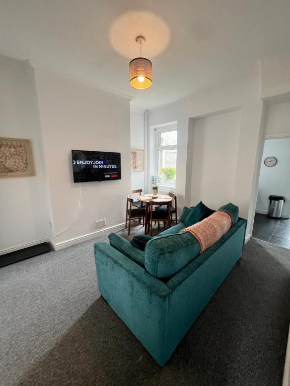 a living room with a couch and a table at Live Like a Local in Barry, 4-Bed Home Near the Beach, Dog-Friendly, with all the Gavin & Stacey Charm! in Barry