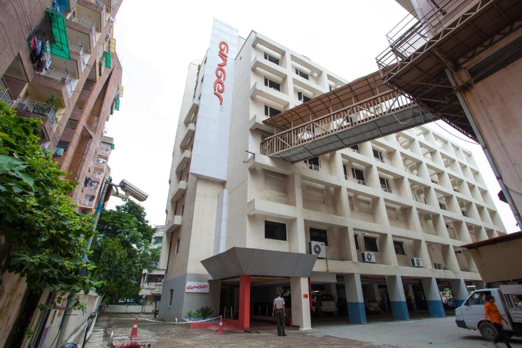 a man standing in front of a building at Ginger Ahmedabad Vastrapur in Ahmedabad