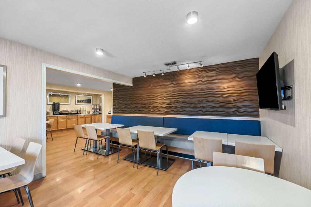 a dining room with tables and chairs and a wall at Best Western Horizon Inn in Medford