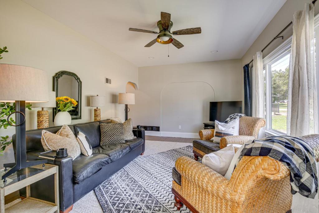 a living room with couches and a ceiling fan at Vino Villa Wine Country Gem Patio and Grill in Defiance