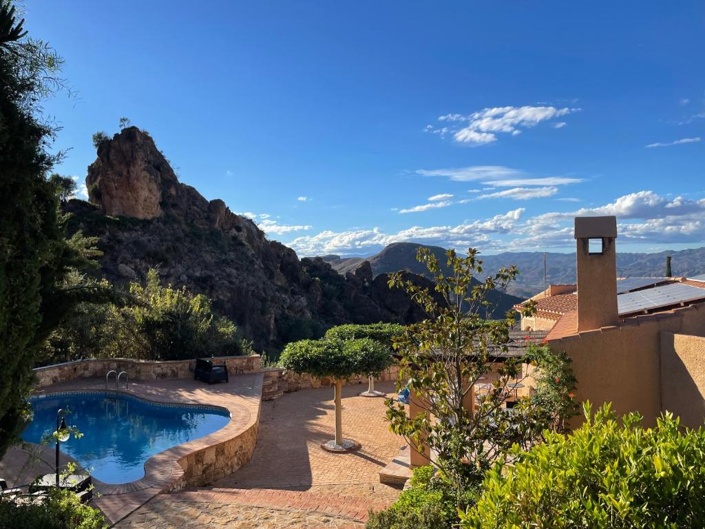 a resort with a pool and mountains in the background at Casa Estrella in Almería