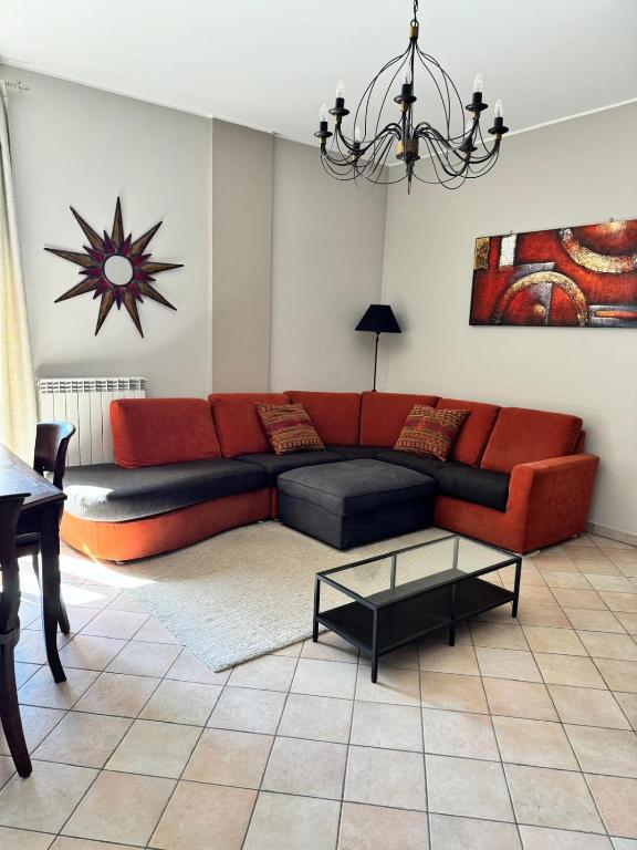 a living room with a red couch and a table at Villa Marina in Marotta