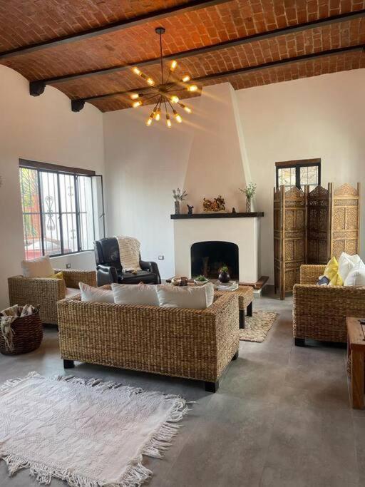 a living room with couches and a fireplace at Casa Moly in Guanajuato