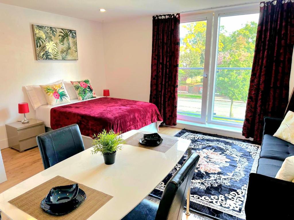 a living room with a bed and a table and a window at Grace Studio in London
