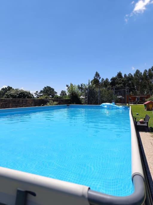 a large swimming pool with blue water at Porto Maia Garden in Maia