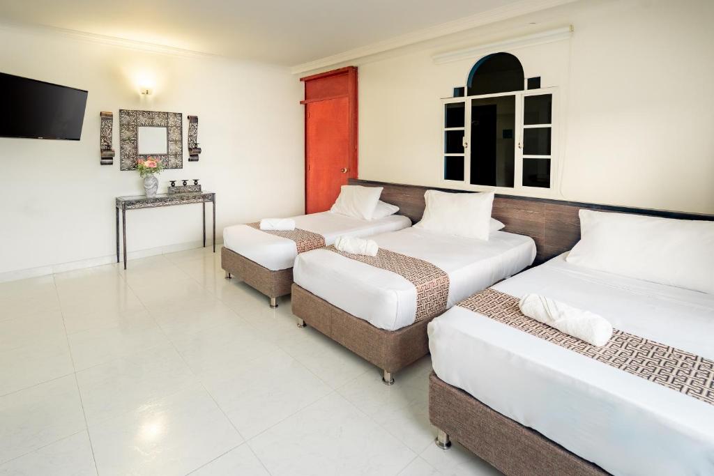 Postel nebo postele na pokoji v ubytování Hotel Americas San Andres Islas Colombia