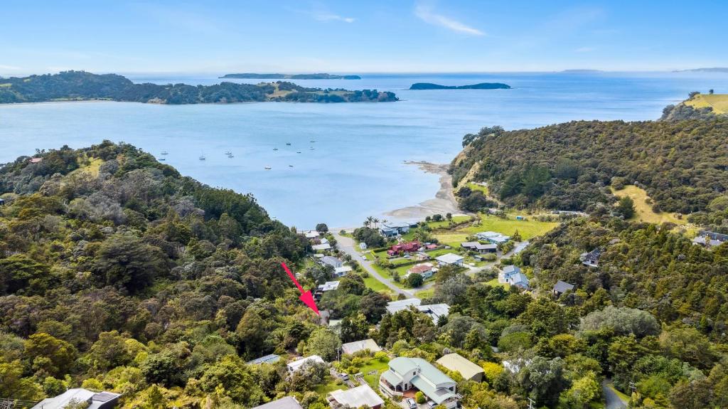 an aerial view of the shoreline of a beach at Opahi TreeHouse - Mahurangi West Holiday Home in Warkworth