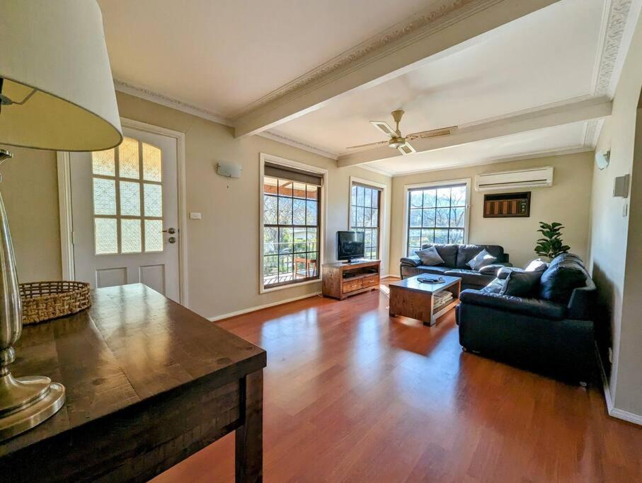a living room with a couch and a table at Cupie's Cabin in Talbingo
