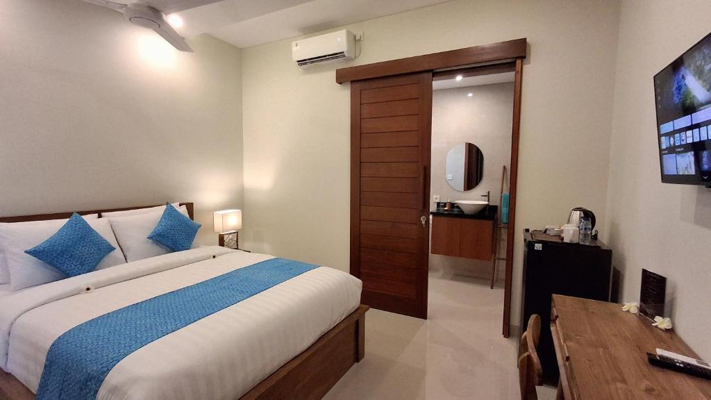 Postel nebo postele na pokoji v ubytování Kutus Bali Guesthouse