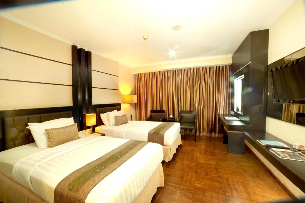 Postel nebo postele na pokoji v ubytování Ros-In Hotel