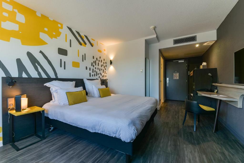 Postel nebo postele na pokoji v ubytování Golden Tulip Roissy Saint Witz