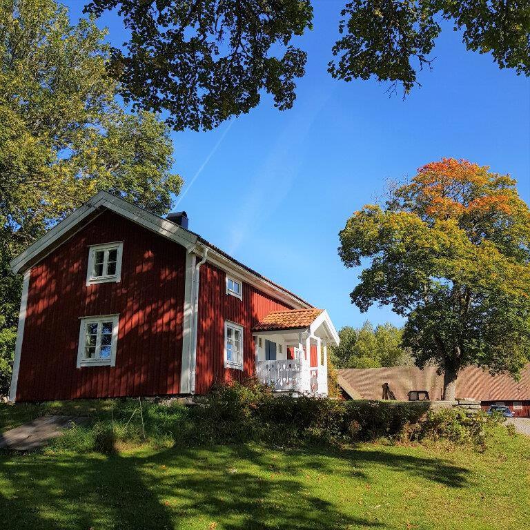 a red house sitting on top of a lush green field at Nice Home In Värnamo With 2 Bedrooms And Wifi in Värnamo
