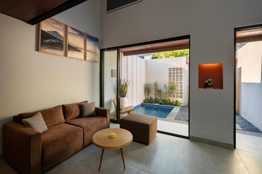a living room with a couch and a table at The New Moon Umalas in Seminyak