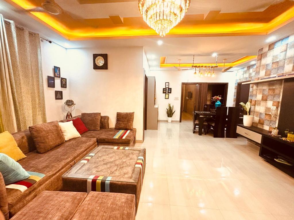 a living room with a couch and a table at ANAisha mansION Near Helipad Rajpur Road shastradhara Hill View in Dehradun