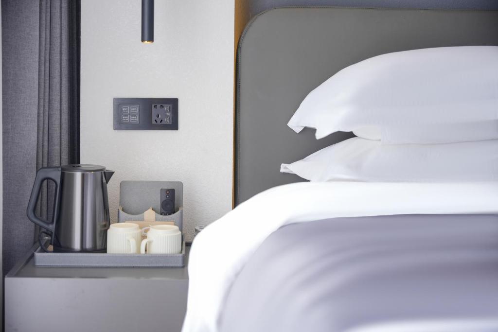 Postel nebo postele na pokoji v ubytování Shanming Boutique Homestay