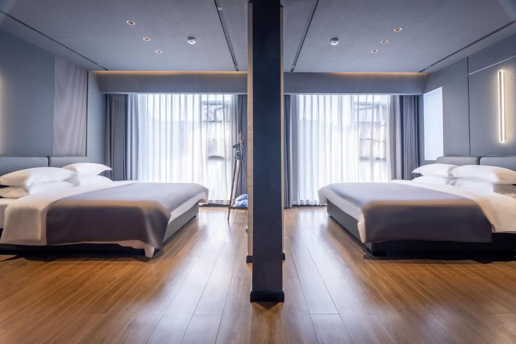 Postel nebo postele na pokoji v ubytování Shanming Boutique Homestay