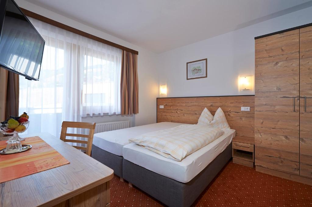 A bed or beds in a room at Pension Gabi