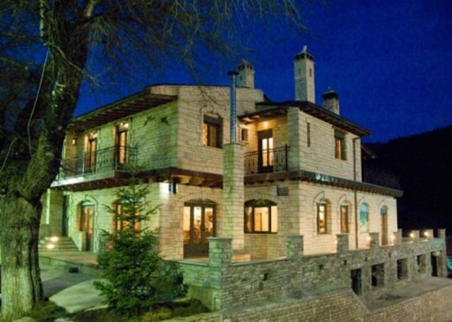 a large stone house at night with its lights on at Lithos in Áyios Nikólaos